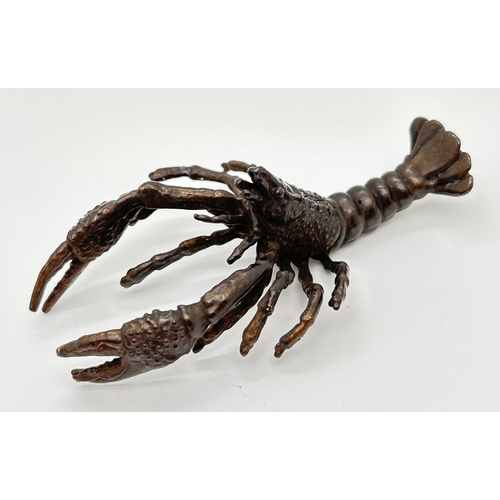 1287 - A small bronze figure modelled as a crayfish. Approx. 9.5cm long.