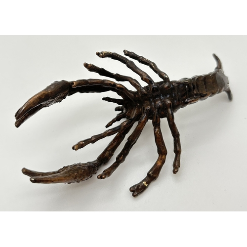 1287 - A small bronze figure modelled as a crayfish. Approx. 9.5cm long.