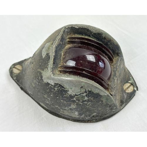 1315 - A vintage boats bow light with red glass lens and cast metal casing, painted black. Approx. 14cm lon... 