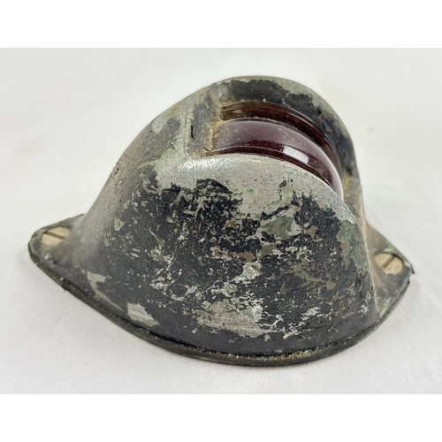 1315 - A vintage boats bow light with red glass lens and cast metal casing, painted black. Approx. 14cm lon... 