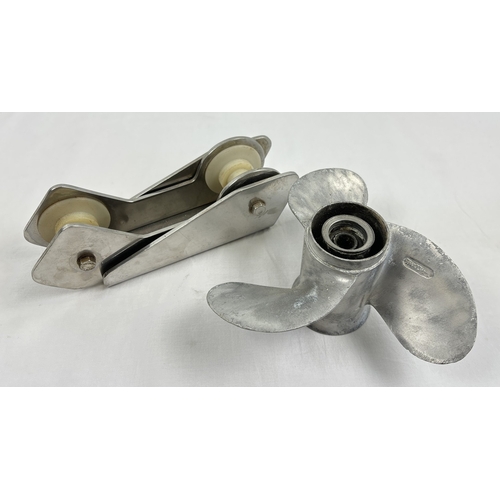 1317 - A 3 blade aluminum boat propellor (9¼ x 10½) together with a stainless steel bow roller (26cm long).... 