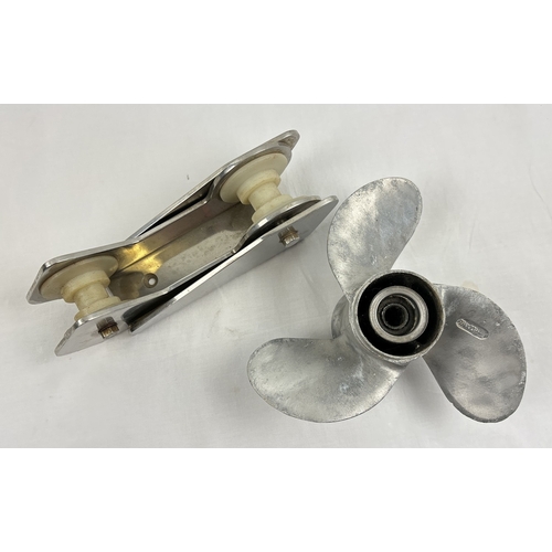 1317 - A 3 blade aluminum boat propellor (9¼ x 10½) together with a stainless steel bow roller (26cm long).... 