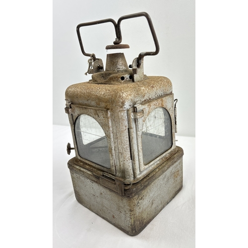 1327 - A vintage Railway Supplies Ltd, Dorking square oil signalling lantern, with 4 glass lenses and swing... 