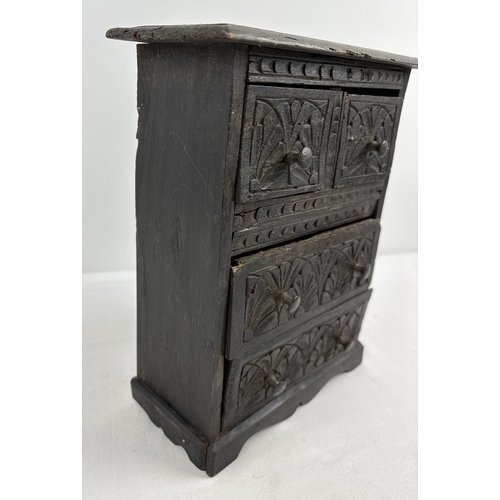 1380 - A handmade antique miniature 2 over 2 chest of drawers. Small bun handles and floral carved detail t... 