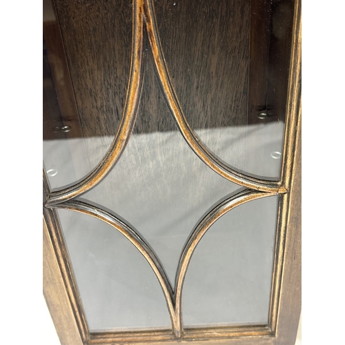 1393 - A pair of vintage dark wood wall hanging cabinets with glazed doors. With carved dentil design moldi... 