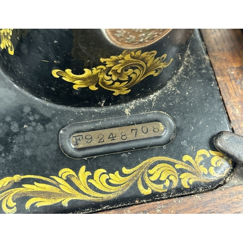 1400 - A Victorian wooden cased Singer hand sewing machine circa 1889 with shuttle style bobbin. Comes with... 