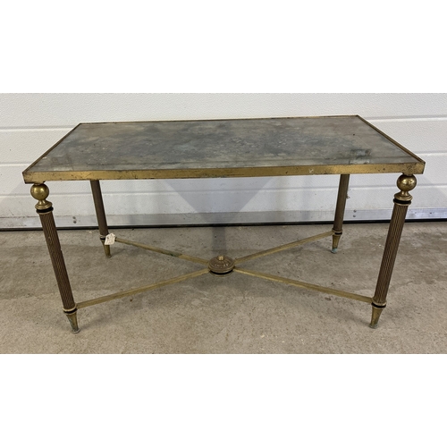 1421 - A vintage brass based coffee table with mirrored glass top, channelled legs and cross stretchers. Ap... 