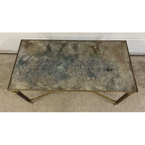 1421 - A vintage brass based coffee table with mirrored glass top, channelled legs and cross stretchers. Ap... 