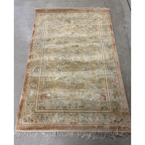 1474 - 2 modern rugs of floral design. Larger tassle ended salmon pink ground rug, approx. 185cm long x 125... 