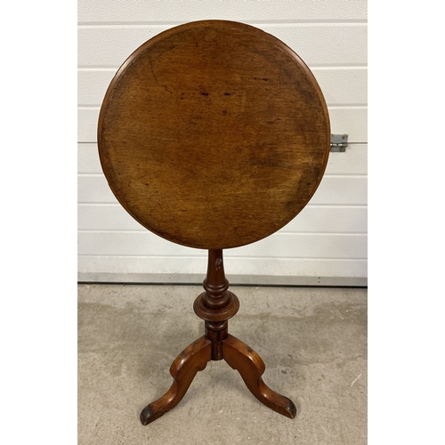 1483 - An antique dark wood tilt top occasional table with turned pedestal and raised on tripod feet. Circu... 