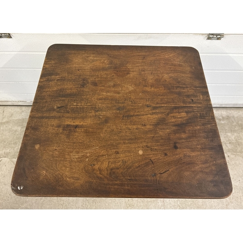 1485 - An antique walnut tilt top table with turned pedestal column and raised on tripod feet. Square shape... 