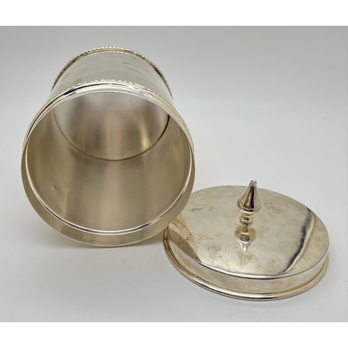 1183 - A modern silver plated lidded coffee canister with imprinted design to front and turned finial lid. ... 