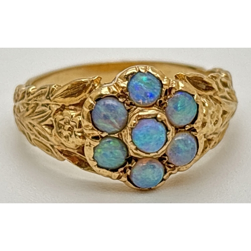 1008 - A vintage 9ct gold floral design ring set with 7 opal cabochons. Flower and leaf decoration to both ... 