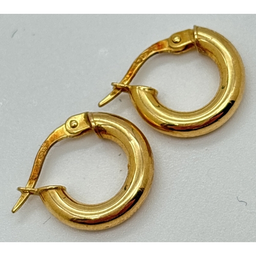 1009 - 2 pairs of 9ct yellow gold hoop style earrings. A small huggie style pair with gold mark to posts to... 