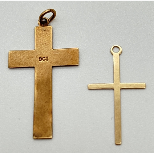 1016 - 2 9ct yellow gold cross shaped pendants. One with floral decoration and heart shaped cartouche, mark... 