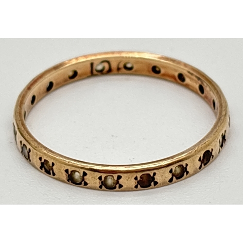 1017 - A vintage 9ct gold and clear stone full eternity ring with 2mm wide band. Marked 9ct inside. Ring si... 