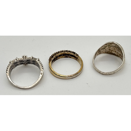 1025 - 3 silver dress rings. A silver gilt half eternity ring set with clear and blue stones, a wishbone st... 