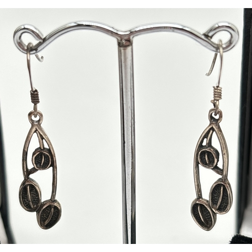 1034 - 3 pairs of silver drop earrings. A pair of Rennie Mackintosh style floral drops with 2 pairs of Celt... 