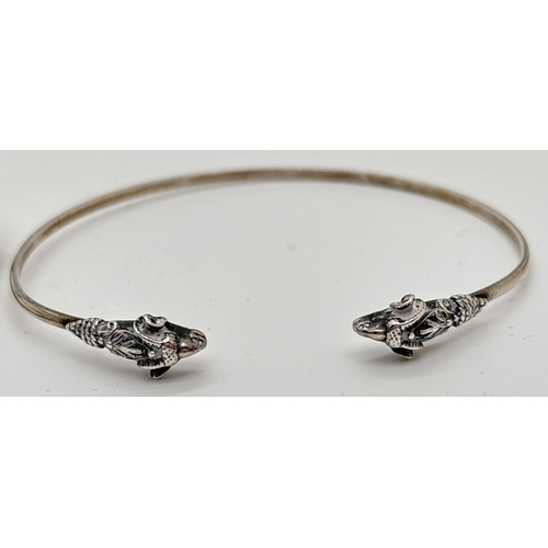 1040 - 2 silver animal themed bangles. A cuff bangle with rams heads and a full open work bangle decorated ... 