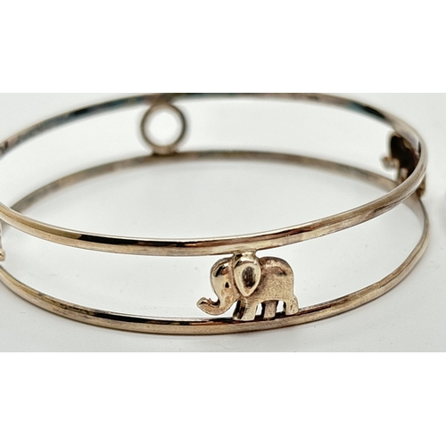 1040 - 2 silver animal themed bangles. A cuff bangle with rams heads and a full open work bangle decorated ... 