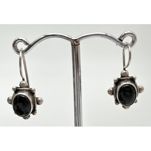 1042 - 3 pairs of silver stone set earrings. A pair of drops set with black onyx cabochons, a pair of half ... 