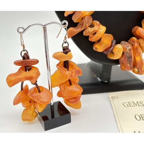 1006 - An amber modern design statement necklace and matching drop earrings by The Dezzler Collection. Made... 