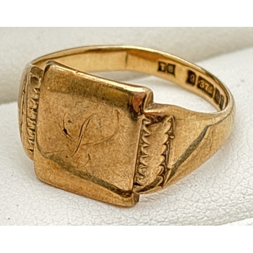 1049 - A vintage 9ct gold men's square shaped signet ring with decoration to shoulders and a very worn init... 