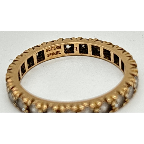 1051 - A vintage 9ct gold full eternity ring set with synthetic white spinel. Gold mark to inside of band. ... 