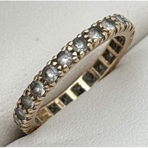 1051 - A vintage 9ct gold full eternity ring set with synthetic white spinel. Gold mark to inside of band. ... 