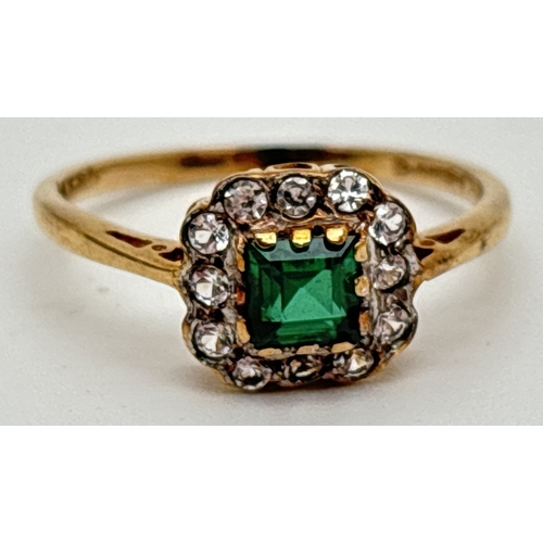 1063 - A 9ct gold created emerald and clear stone cluster style ring. Central square cut emerald surrounded... 