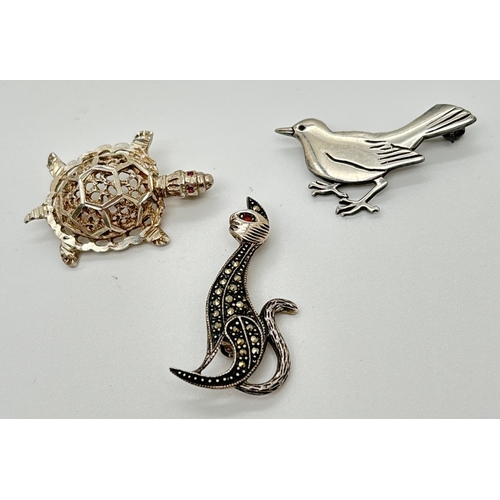 1065 - 3 silver animal and bird brooches. A pierced work turtle with small ruby set eyes, a small silver bi... 