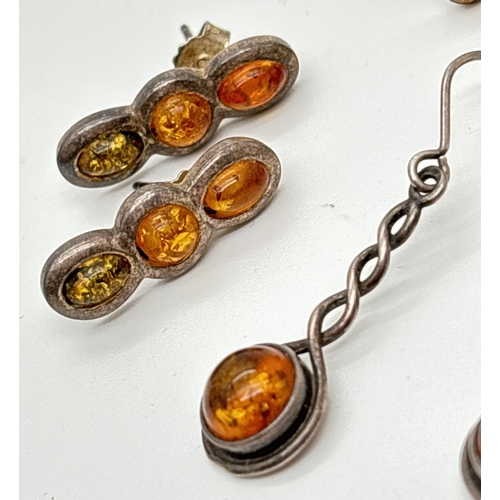 1066 - 3 pairs of amber set silver and white metal earrings. A pair of 3 stone studs set with honey and gre... 