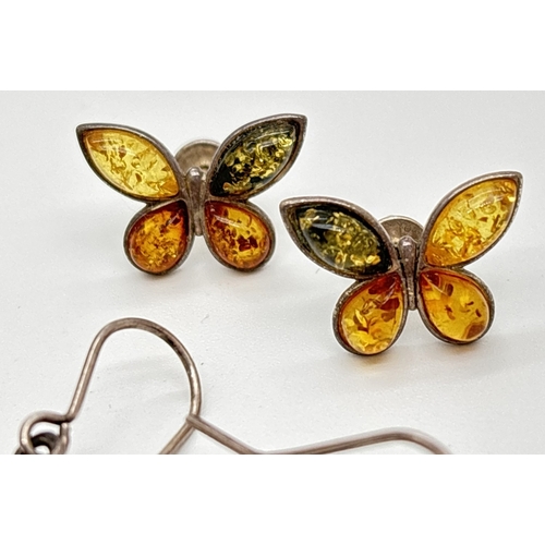 1066 - 3 pairs of amber set silver and white metal earrings. A pair of 3 stone studs set with honey and gre... 