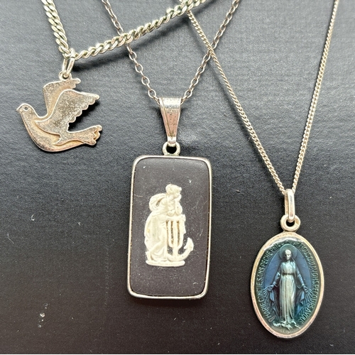 1069 - 3 silver and white metal pendant necklaces. A black Wedgwood Jasperware pendant on a 17