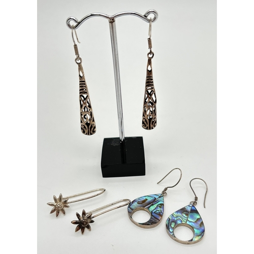 1070 - 3 pairs of silver and white metal drop style earrings. A pair of teardrops set with abalone shell, a... 