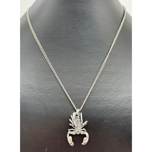 1072 - A silver scorpion pendant on a 20