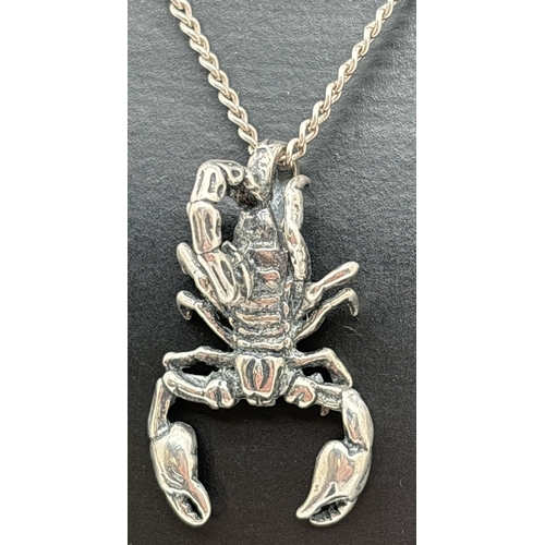 1072 - A silver scorpion pendant on a 20