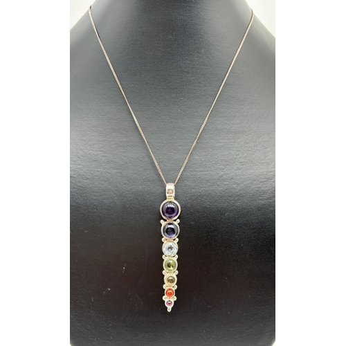 1074 - A silver and semi precious 7 stone chakra pendant on a 16