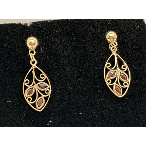 1084 - A pair of yellow gold leaf design drop earrings, each set with 3 small marquise cut garnets. 9ct gol... 