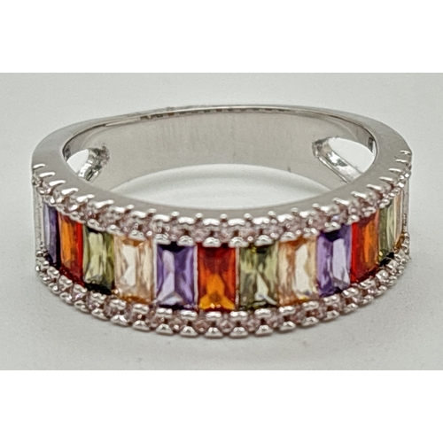 1091 - A rhodium plated cocktail band ring set with Swarovski crystals. Half eternity style ring set with y... 