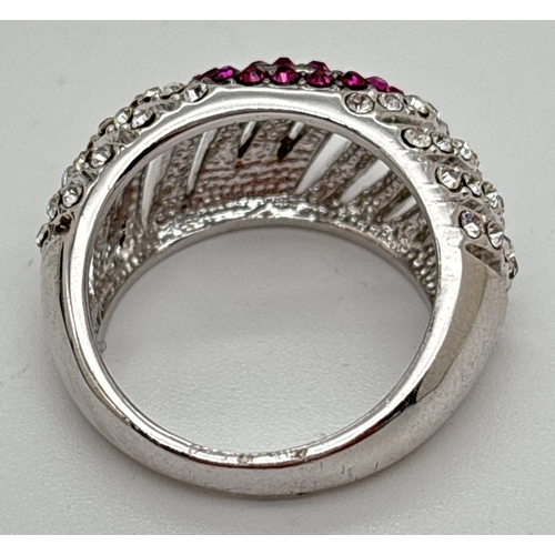 1094 - A rhodium plated dome style cocktail ring set with red and clear Swarovski crystals. 3 rows of red c... 