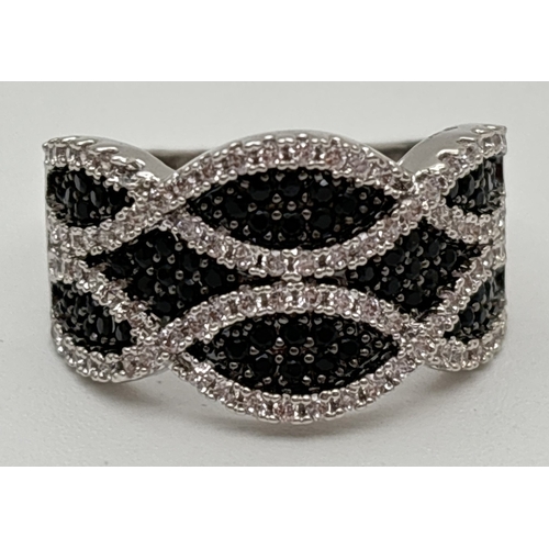 1097 - A rhodium plated cocktail ring set with Swarovski crystals in a crossover twist style 2 row design. ... 