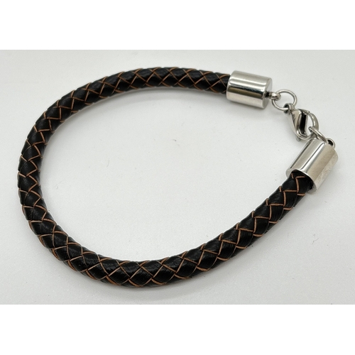 1101 - An unboxed Simon Carter, London plaited brown leather bracelet with silver tone hardware and lobster... 