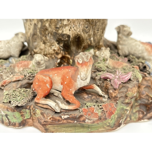 1227 - A 19th century large Staffordshire pottery animal figure group. Figures of 4 sheep and a deer sat wi... 
