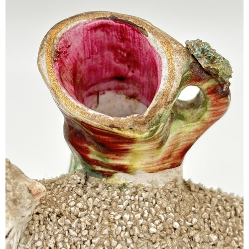 1228 - A 19th century Staffordshire sheep spill vase with gilt detail and tufted grass to base and rim of v... 
