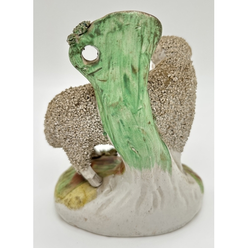 1228 - A 19th century Staffordshire sheep spill vase with gilt detail and tufted grass to base and rim of v... 