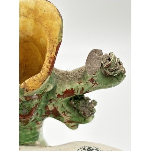 1229 - 3 Staffordshire 19th century figures. A sponge finished black and white horse spill vase, a flat bac... 