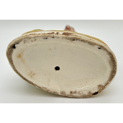 1233 - A Staffordshire pottery figure of a red squirrel on an oak tree. Some flaking to paintwork, small ch... 