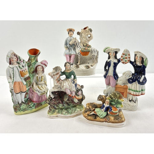 1235 - A collection of 5 Staffordshire figures, spill vases and flat back figures, to include a young boy a... 