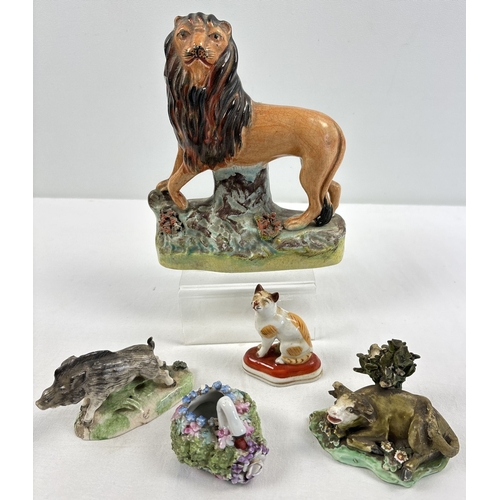 1236 - A collection of antique ceramic figures. To include Staffordshire Lion, Chelsea ginger and white cat... 